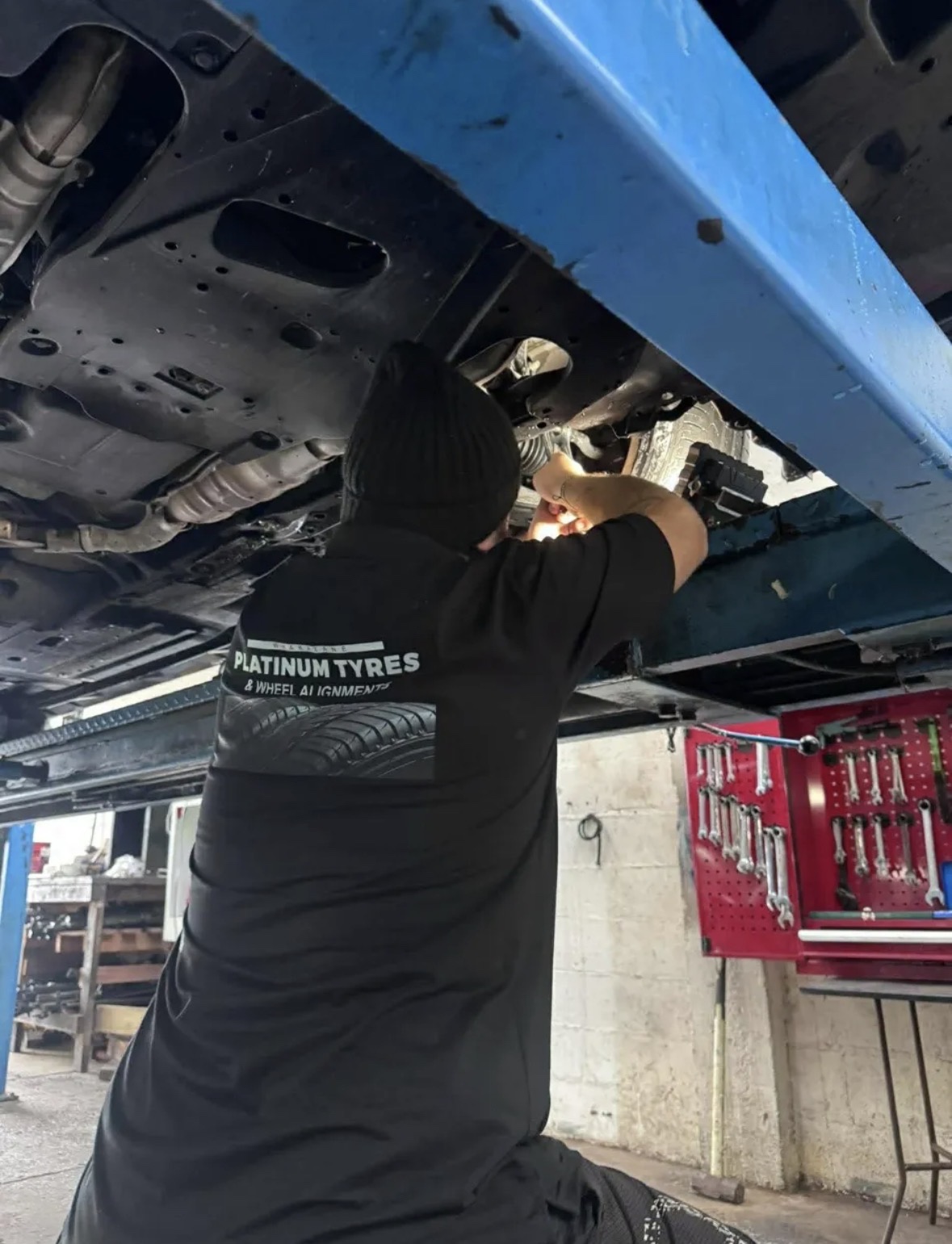 Mechanic working under a vehicle at Whakatāne Platinum Tyres